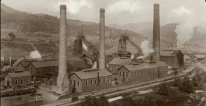Abercynon Colliery, vintage photo showing pit head workings with three large chimneys.