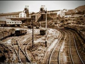 a view of A South Wales Valley Town After Coal Arrived 1900@, Th image shows a colliery and some new rail tracks where once there were sheep grazing